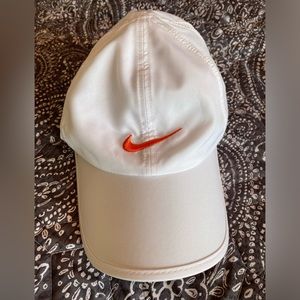 White Nike dri fit Velcro hat.  Orange swoosh